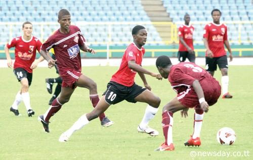 THERE'S St Anthony's striker Garvin Samaroo, centre, giving Mucurapo defender Tevon Eve a 